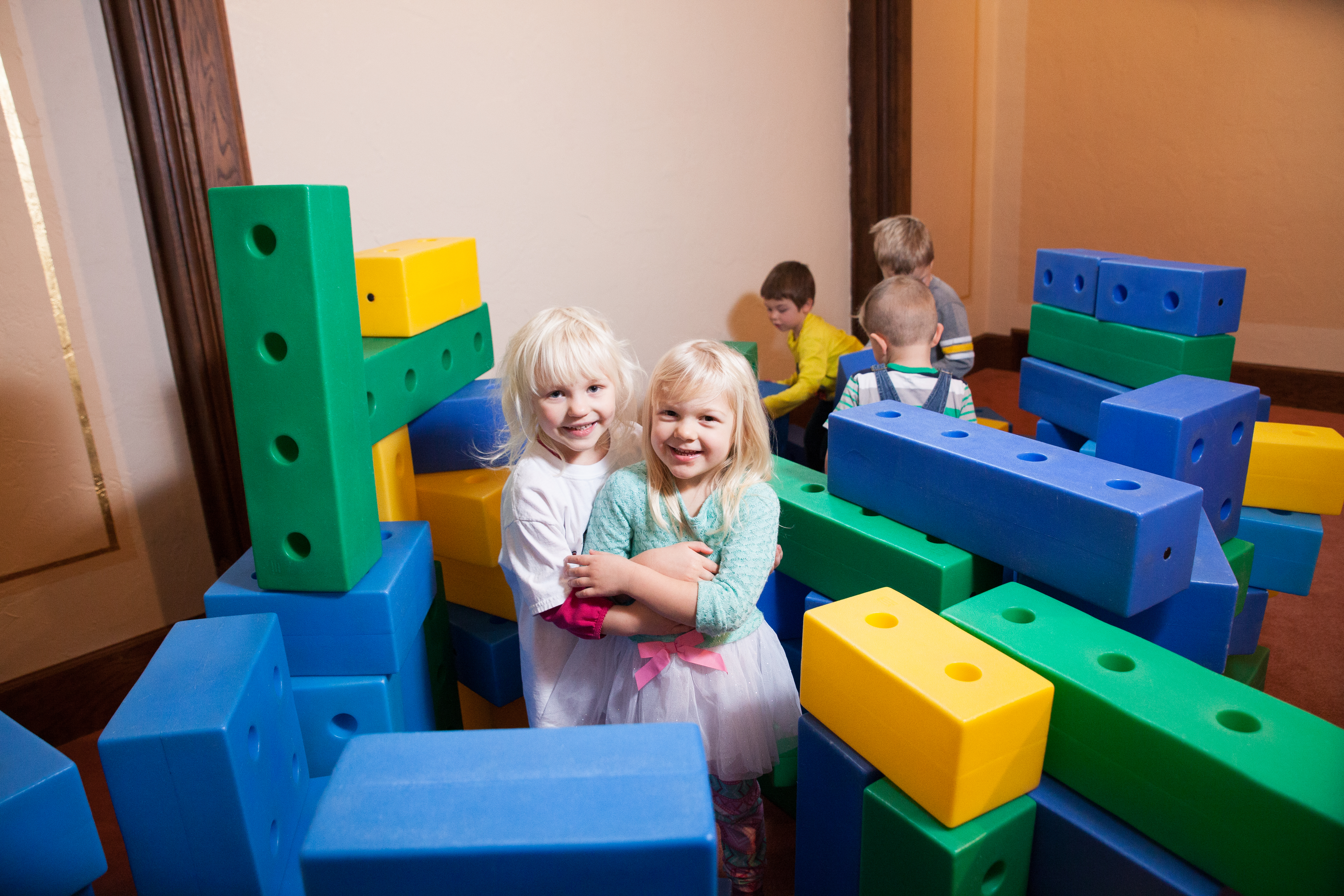 children play with large blocks at Community Child Care Center