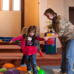 Community Child Care Center staff member works with kids