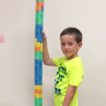 boy stacks toys at Community Child Care Center